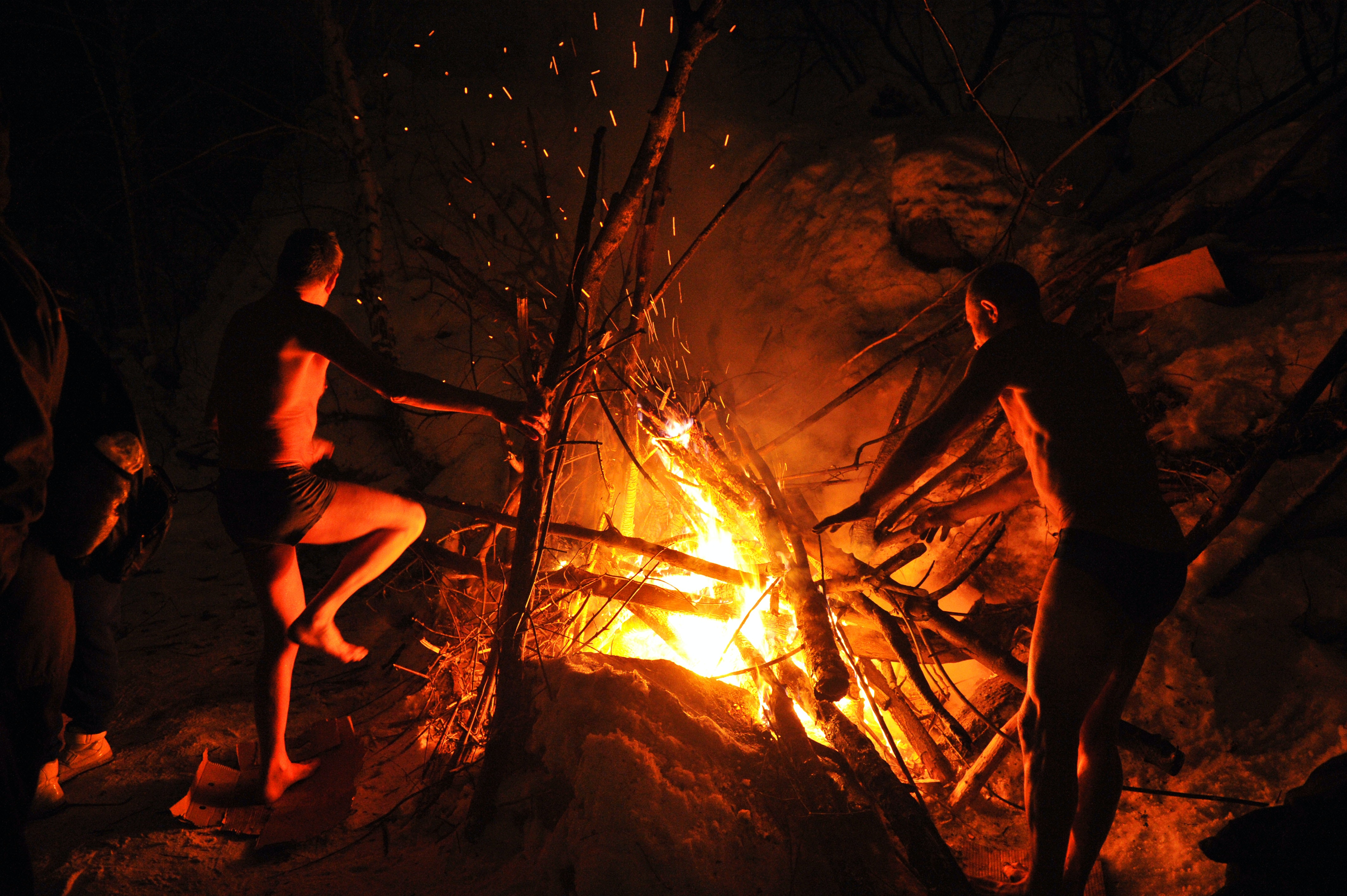 Photo by Sh-Andrei: https://www.pexels.com/photo/two-shirtless-men-standing-near-a-campfire-8883963/